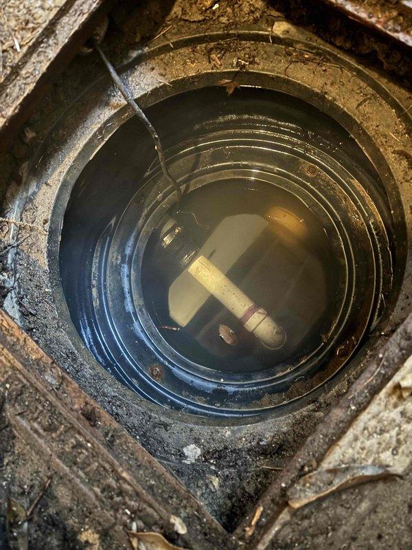 Responded to service call for malfunctioning sump pump system with water pooling in basement. Upon inspection, found sump pump operational with power indicator light illuminated, but system failing to effectively remove water. Replaced tailpipe (TP) discharge line and cleared debris from outdoor drainage area and sump pit. Observed significant sediment accumulation in pit and standing water with partially submerged float switch component. System appears to be under warranty coverage and may require follow-up inspection to verify proper pump cycling and discharge flow. Responded to service call for malfunctioning sump pump system with water pooling in basement. Upon inspection, found sump pump operational with power indicator light illuminated, but system failing to effectively remove water. Replaced tailpipe (TP) discharge line and cleared debris from outdoor drainage area and sump pit. Observed significant sediment accumulation in pit and standing water with partially submerged float switch component. System appears to be under warranty coverage and may require follow-up inspection to verify proper pump cycling and discharge flow.