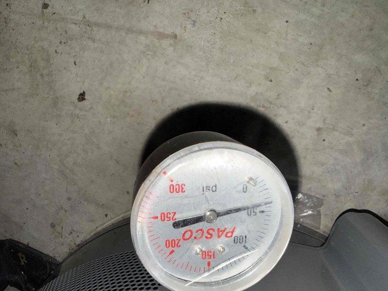 Inspected the under-sink cabinet to assess existing drain and supply configurations for a kitchen remodel with a new sink, documenting the PVC drain assembly with P-trap, capped drain stub-out, braided supply lines, garbage disposal, and electrical connections requiring modification. Performed a pressure test on the plumbing system with a gauge, recording approximately 50–60 psi, to verify supply line integrity prior to re-piping to accommodate the new sink. Inspected the under-sink cabinet to assess existing drain and supply configurations for a kitchen remodel with a new sink, documenting the PVC drain assembly with P-trap, capped drain stub-out, braided supply lines, garbage disposal, and electrical connections requiring modification. Performed a pressure test on the plumbing system with a gauge, recording approximately 50–60 psi, to verify supply line integrity prior to re-piping to accommodate the new sink.