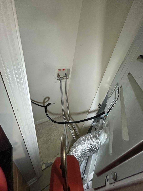 Responded to a reported water leak originating from an upper unit and migrating to the unit below, and inspected the water heater and laundry closet. The water heater showed heavy corrosion staining at the base, deteriorated sealant on the floor, and a clamped supply fitting near the bottom, indicating prior moisture exposure, while the laundry closet's washing machine supply hoses, valves, and dryer vent showed no visible leaks or damage. Findings were documented with photos for further evaluation and repair. Responded to a reported water leak originating from an upper unit and migrating to the unit below, and inspected the water heater and laundry closet. The water heater showed heavy corrosion staining at the base, deteriorated sealant on the floor, and a clamped supply fitting near the bottom, indicating prior moisture exposure, while the laundry closet's washing machine supply hoses, valves, and dryer vent showed no visible leaks or damage. Findings were documented with photos for further evaluation and repair.