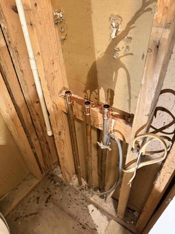 Installed a new electric water heater in the utility closet, set within a metal drain pan, with new copper supply piping, brass fittings, a shutoff valve, and a flexible connector to the tank. Water supply and electrical connections were completed, and the installation was left free of visible leaks, rust, or damage, with the manufacturer warranty documentation attached to the unit. Installed a new electric water heater in the utility closet, set within a metal drain pan, with new copper supply piping, brass fittings, a shutoff valve, and a flexible connector to the tank. Water supply and electrical connections were completed, and the installation was left free of visible leaks, rust, or damage, with the manufacturer warranty documentation attached to the unit.