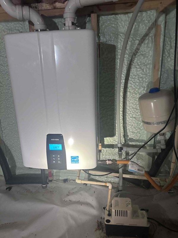 Inspected a wall-mounted Navien tankless water heater with condensate pump, expansion tank, and PVC venting in preparation for descaling and flushing service. Found the inlet water filter screen heavily clogged with sediment and debris, indicating the unit requires a flush and filter cleaning to restore proper flow and efficiency; the customer also requested the same service for a second unit at an additional property. Inspected a wall-mounted Navien tankless water heater with condensate pump, expansion tank, and PVC venting in preparation for descaling and flushing service. Found the inlet water filter screen heavily clogged with sediment and debris, indicating the unit requires a flush and filter cleaning to restore proper flow and efficiency; the customer also requested the same service for a second unit at an additional property.