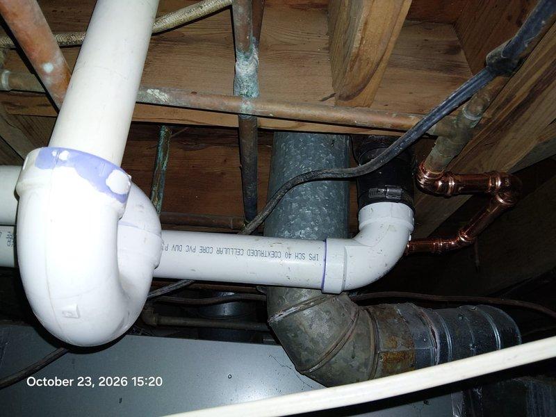 Replaced deteriorated cast iron drain piping with Schedule 40 PVC DWV, including a new P-trap and shielded rubber couplings with stainless clamps to transition to the existing drain line, and re-soldered affected copper supply connections with new fittings. Removed and replaced the exterior hose bib with a new brass lever-handle sillcock, secured to the wall and sealed at the siding penetration. Replaced deteriorated cast iron drain piping with Schedule 40 PVC DWV, including a new P-trap and shielded rubber couplings with stainless clamps to transition to the existing drain line, and re-soldered affected copper supply connections with new fittings. Removed and replaced the exterior hose bib with a new brass lever-handle sillcock, secured to the wall and sealed at the siding penetration.