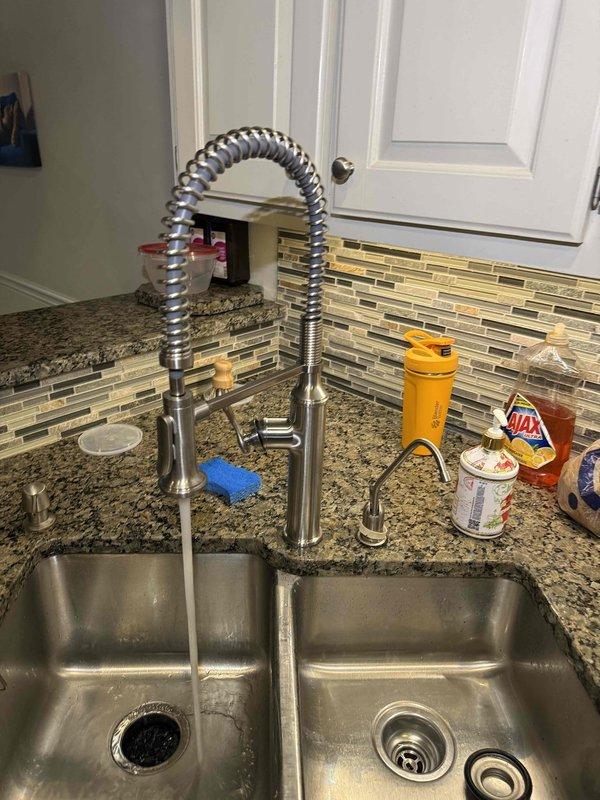 Installed customer-supplied brushed-nickel pull-down kitchen faucet on the double-basin sink and verified proper flow and drainage with no leaks. Mounted and connected the customer-supplied garbage disposal beneath the left basin, tying its discharge into the existing PVC drain assembly and confirming secure connections and normal operation. Installed customer-supplied brushed-nickel pull-down kitchen faucet on the double-basin sink and verified proper flow and drainage with no leaks. Mounted and connected the customer-supplied garbage disposal beneath the left basin, tying its discharge into the existing PVC drain assembly and confirming secure connections and normal operation.