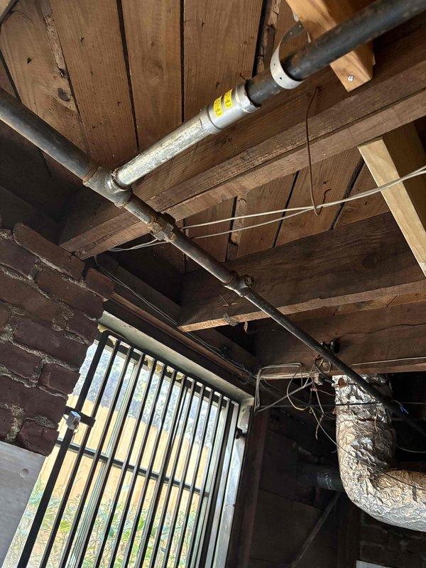 Repaired the gas supply piping serving the heating appliance, addressing the identified leak and deficient connections at the threaded black iron fittings and clamped section. Replaced and re-secured the affected piping and fittings with proper thread sealant, then pressure tested and leak checked all joints to confirm a tight, code-compliant installation. Verified safe appliance operation, confirming a stable blue burner flame and proper ignition. Repaired the gas supply piping serving the heating appliance, addressing the identified leak and deficient connections at the threaded black iron fittings and clamped section. Replaced and re-secured the affected piping and fittings with proper thread sealant, then pressure tested and leak checked all joints to confirm a tight, code-compliant installation. Verified safe appliance operation, confirming a stable blue burner flame and proper ignition.