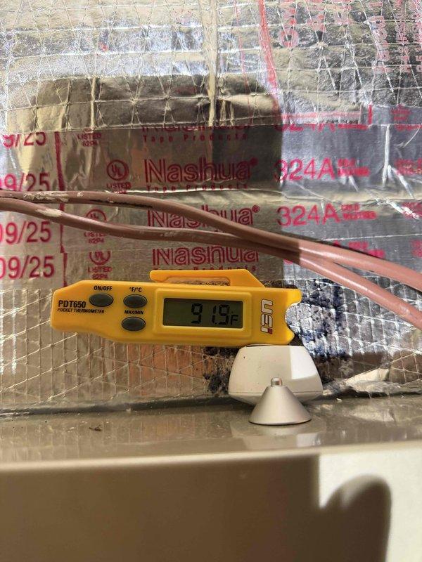 Responded to callback for recent installation where customer reported heating system not exceeding 65°F despite 70°F thermostat setting. Inspected electrical connections in control panel, verified proper wiring configuration with no loose connections. Temperature readings using digital thermometer showed discharge temperature of 91.9°F, confirming system is producing adequate heat. Determined issue was likely thermostat calibration. Recalibrated thermostat and confirmed proper operation with customer.