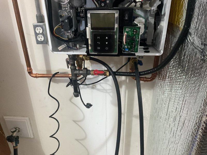 Completed routine maintenance service on customer's HVAC system. Performed tankless water heater inspection and identified need for system flush. Advised customer about maintenance plan coverage limits and arranged to mail requested warranty documentation and service contract.