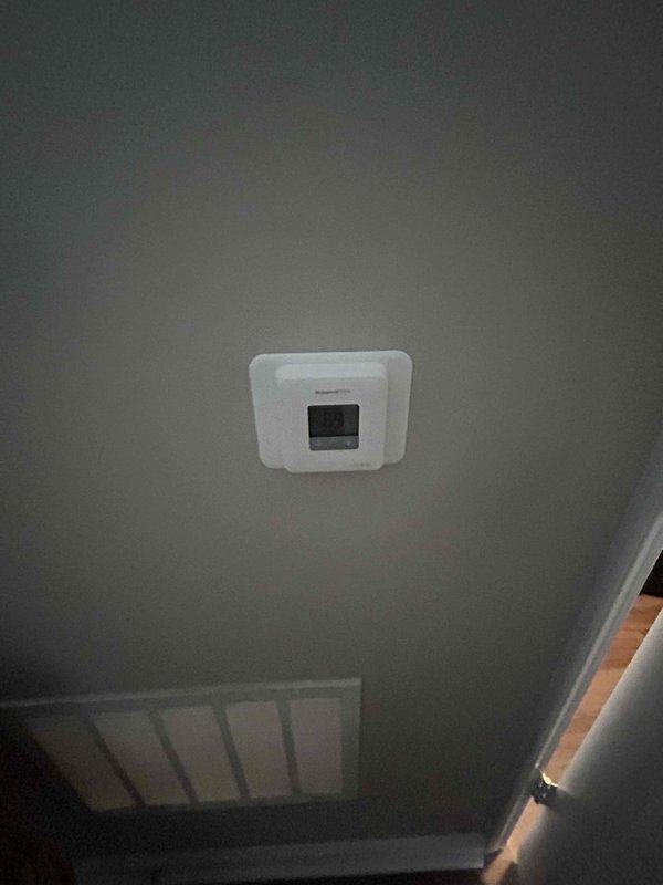 Conducted site inspection for full system replacement at residential property with Nolan, the onsite supervisor. Assessment included evaluation of existing ceiling-mounted thermostat and garage environment where potential equipment installation would occur. Documented current system configuration to prepare comprehensive replacement quote.