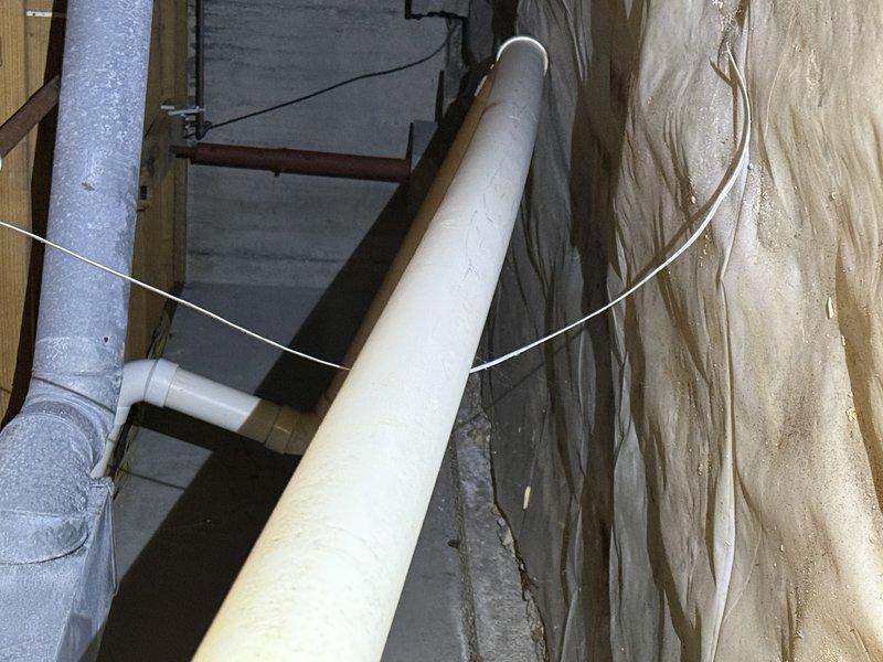 Inspected ductwork in crawl space to evaluate airflow issues. Documented existing PVC piping configuration and examined adjacent HVAC components with exposed framing. Identified areas where modifications would be needed to improve air circulation throughout the system.