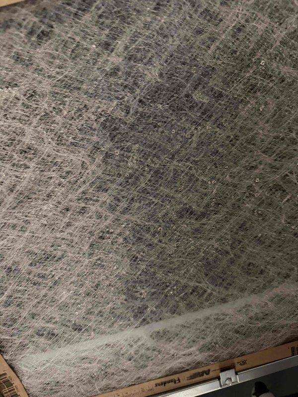 Performed scheduled maintenance repair involving replacement of severely clogged HVAC filter. Visual inspection revealed significant dust accumulation and matting of the filter media, which was restricting proper airflow. Removed and replaced the filter to restore system efficiency and proper air circulation.