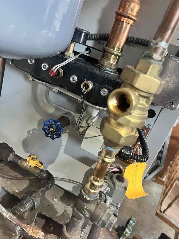 Successfully installed new backflow preventer assembly on boiler system with complete copper pipe rerouting. System includes expansion tank, circulation pump, and proper valve configuration to ensure code compliance and optimal system function.