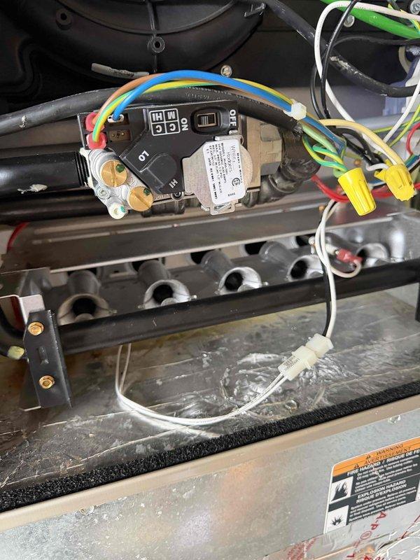 Performed 2-hour warranty service on HVAC system involving inspection of control module and gas valve assembly. Checked electrical connections on control board including blue, yellow, green and red wiring. Verified proper operation of digital display and system functionality.