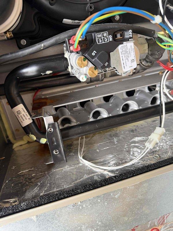 Performed 2-hour warranty service on HVAC system involving inspection of control module and gas valve assembly. Checked electrical connections on control board including blue, yellow, green and red wiring. Verified proper operation of digital display and system functionality.