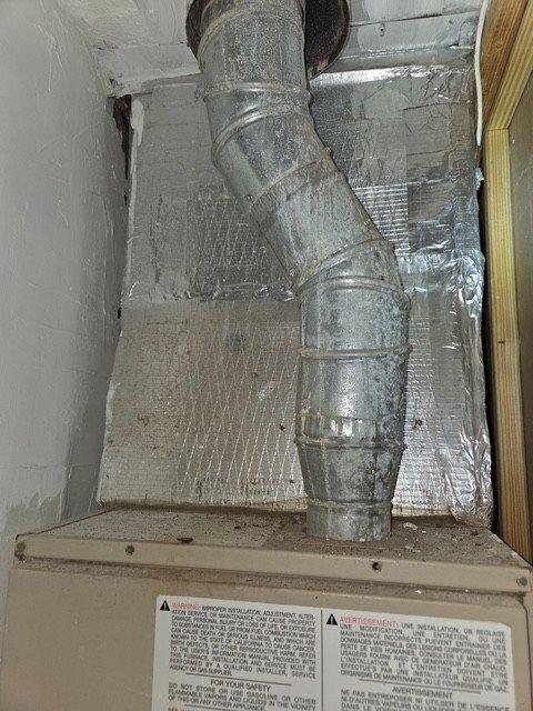 Performed detailed assessment for replacement of existing Amana 80 SSE II gas furnace. Current unit shows signs of aging and is installed in utility closet with S-shaped galvanized steel ductwork connecting to the ceiling. Documented existing installation configuration and clearances to determine appropriate replacement specifications.