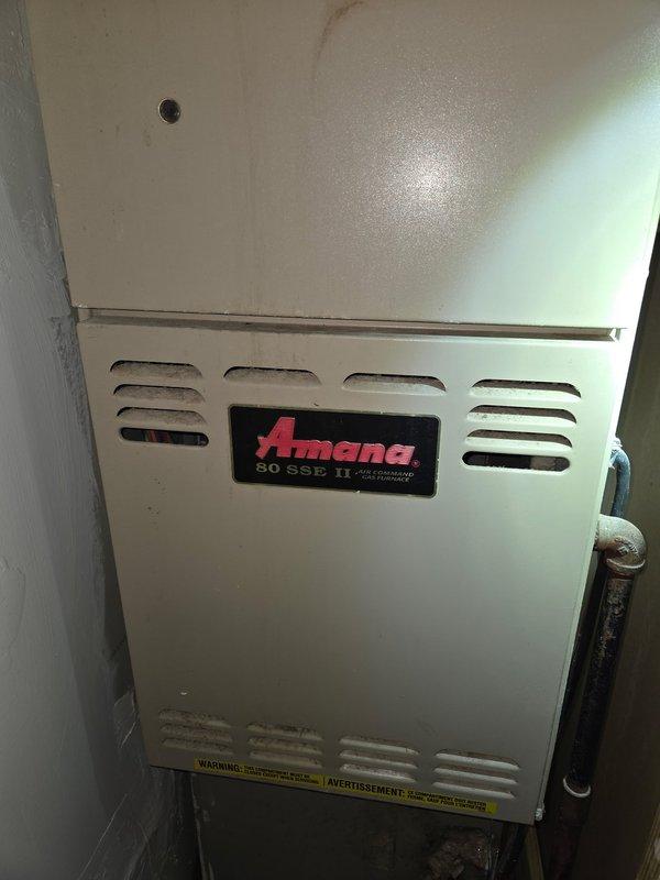 Performed detailed assessment for replacement of existing Amana 80 SSE II gas furnace. Current unit shows signs of aging and is installed in utility closet with S-shaped galvanized steel ductwork connecting to the ceiling. Documented existing installation configuration and clearances to determine appropriate replacement specifications.