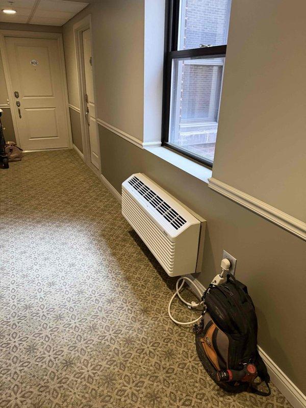 Successfully replaced three Amana heat pump PTAC units with outdoor sensors (model PTH153J50AX) in the 6th, 8th, and 9th floor lobby areas as specified. Units were properly installed, connected to power, and programmed to maintain desired temperature settings of 68 degrees as verified by digital thermostat display.