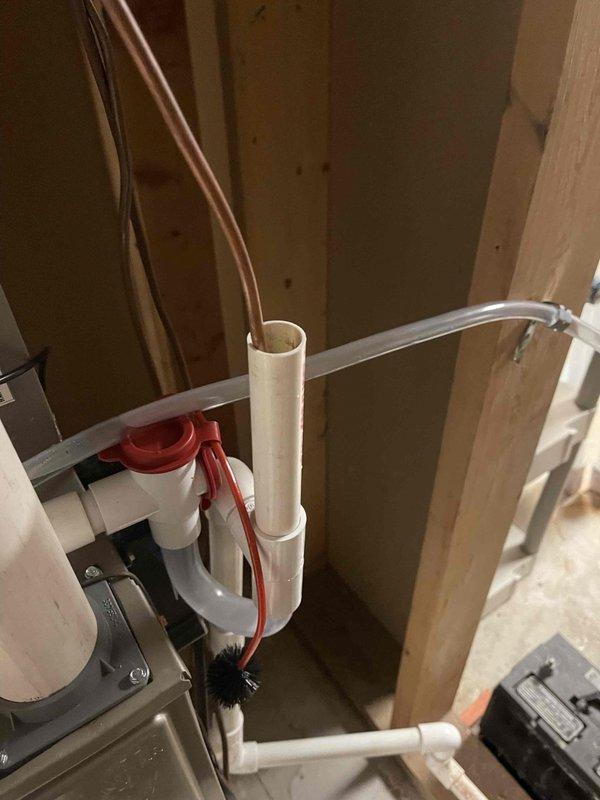 Responded to a water leak callback where investigation revealed moisture issues within the wall cavity. Inspected the PVC drain pipe system including cleanout access point and connecting segments. Found improper installation and water intrusion in the ventilation ducting with evidence of moisture damage to the insulation and surrounding structure.