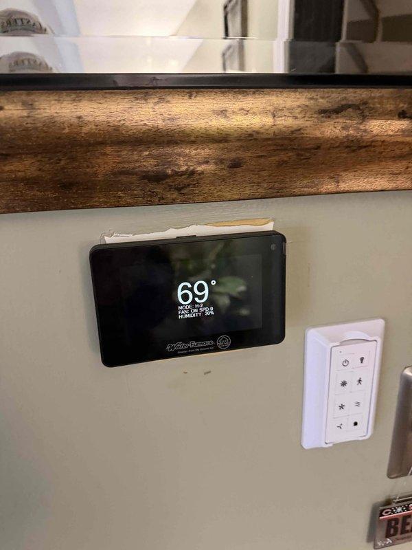 Identified malfunctioning geothermal system that was repeatedly tripping a 60A breaker in the dedicated sub-panel adjacent to the unit. Reset circuit breakers to temporarily restore operation. Installed new communicating thermostat and Symphony module to enable Wi-Fi connectivity for remote system control and monitoring. Parts inventory stored on garage shelf for future maintenance.