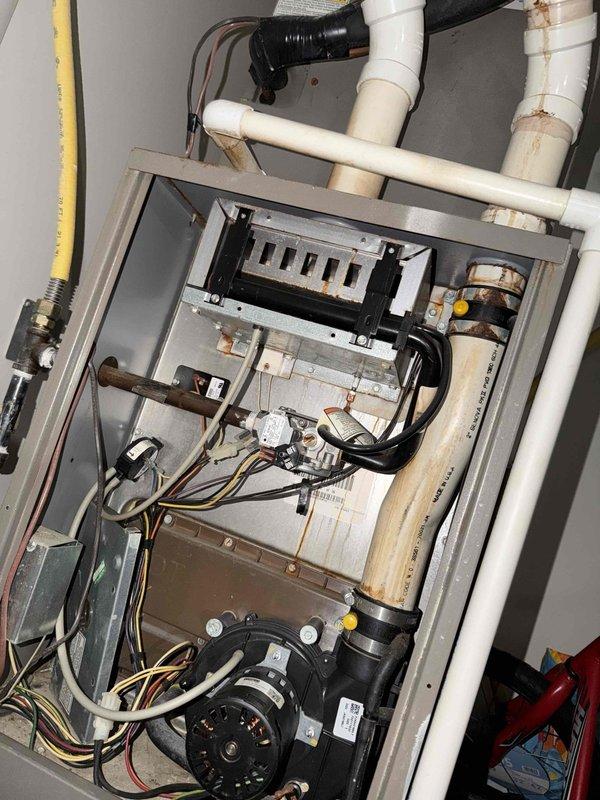 Diagnosed no heat complaint at Red Maple Grove property, finding signs of age and wear in 10+ year old furnace system with rust, water staining on PVC connections, and dusty electrical components. Completed inspection of internal components and wiring connections to identify failure points requiring repair - pending approval from property management.