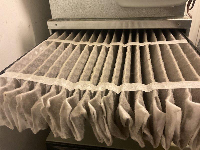 Inspected furnace system after reported thermostat malfunction. Found severely clogged air filter, replaced with new pleated filter and verified proper installation in relay panel housing. System now operating correctly with improved airflow.