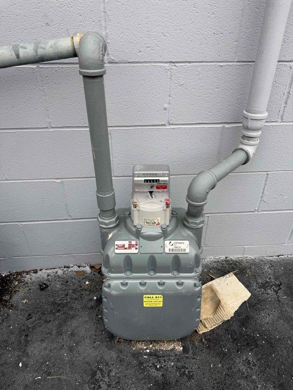 Responded to service callback regarding gas meter verification for Cricket Wireless. Confirmed meter #756512 is unlocked and shared with China Inn as reported by maintenance personnel. Documented with photographs that meter #357322 (which is locked) does not serve Cricket Wireless. Images taken of both meters and valve assembly for verification purposes.