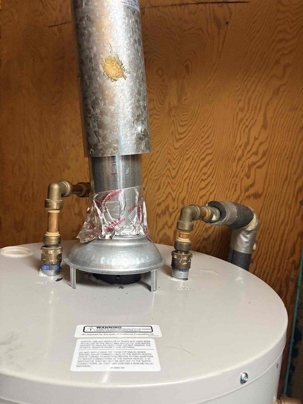 Identified and repaired a water leak at the connection points of a newly installed water heater. Inspection revealed condensation/moisture at the pipe junctions where insulation was damaged, requiring resealing of brass fittings to eliminate the persistent drip.