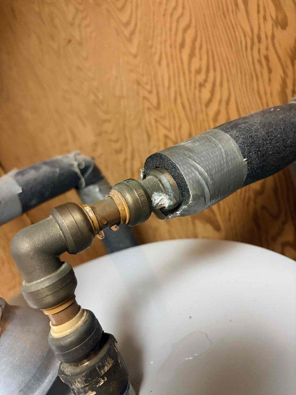 Identified and repaired a water leak at the connection points of a newly installed water heater. Inspection revealed condensation/moisture at the pipe junctions where insulation was damaged, requiring resealing of brass fittings to eliminate the persistent drip.