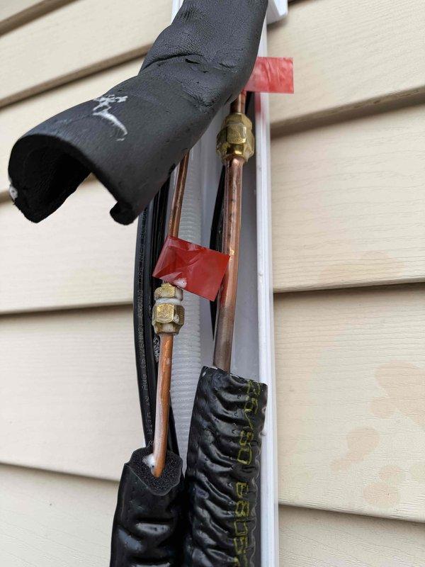 Completed quoted repairs on mini-split system, including installation of insulated refrigerant lines with appropriate service valve connections. System was properly mounted to exterior wall on concrete pad, with all brass fittings secured and service valves accessible for future maintenance.