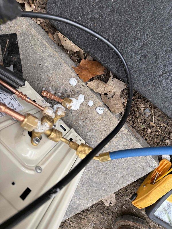 Completed quoted repairs on mini-split system, including installation of insulated refrigerant lines with appropriate service valve connections. System was properly mounted to exterior wall on concrete pad, with all brass fittings secured and service valves accessible for future maintenance.