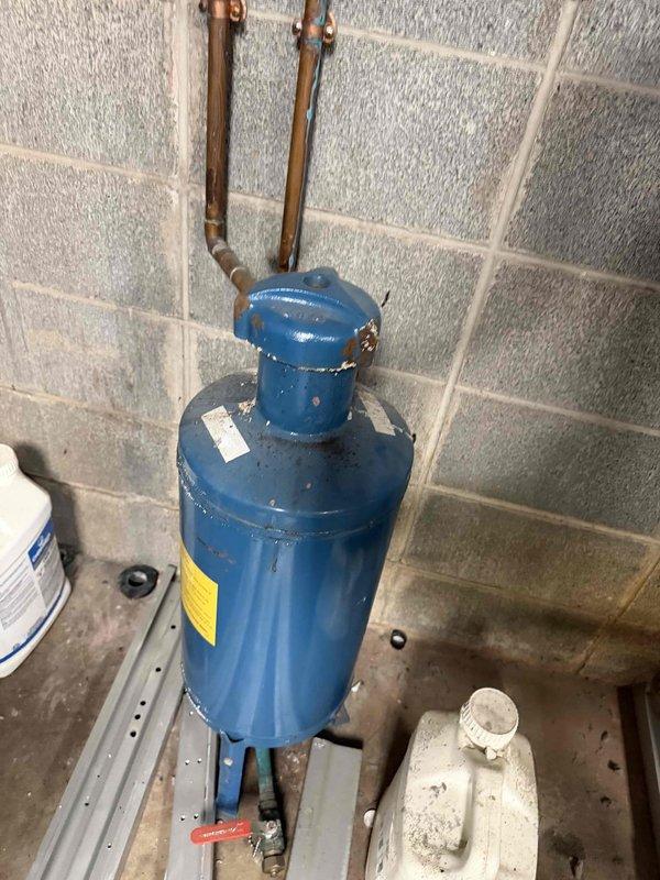 Performed commercial tune-up service on two church boilers. Inspected blue cylindrical pressure vessel with copper pipe connections and examined red pump assemblies mounted to copper piping network. System shows normal wear consistent with age. Completed routine maintenance to ensure proper operation for the heating season.