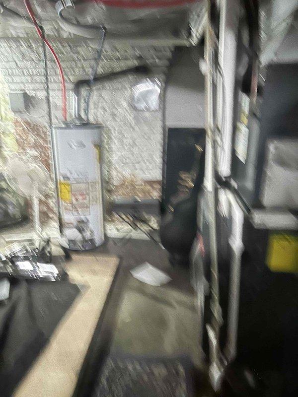 Completed estimate for replacement of gas furnace with damaged heat exchanger and installation of new tankless water heater to replace current leaking unit. Prior repair credit will be applied to this replacement service. Photos documented existing HVAC equipment and water heater in basement mechanical room.