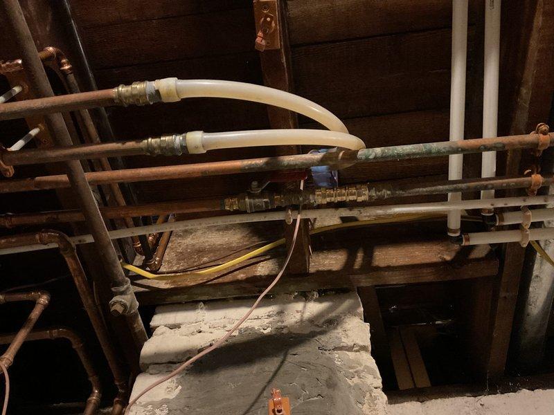 Completed quoted repair work on aging plumbing system with significant copper pipe oxidation. Inspected and serviced connection points between copper and PVC piping in utility space, where various electrical control wiring runs alongside the piping infrastructure.