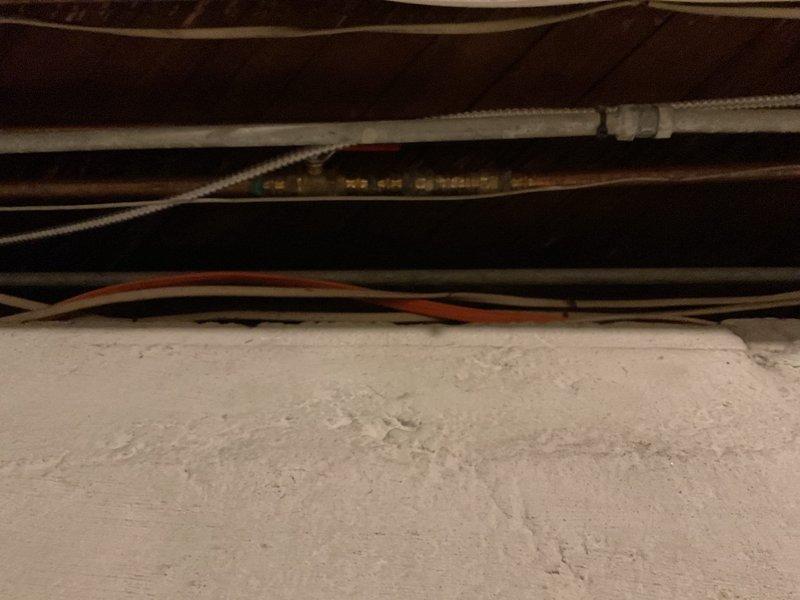 Completed quoted repair work on aging plumbing system with significant copper pipe oxidation. Inspected and serviced connection points between copper and PVC piping in utility space, where various electrical control wiring runs alongside the piping infrastructure.