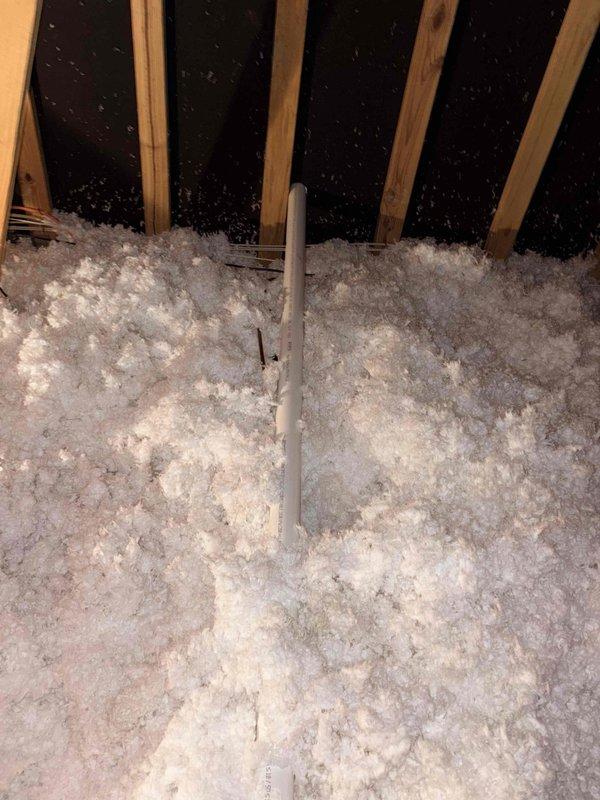 Inspected customer's concern about improper furnace venting and potential exhaust recirculation into the home. Conducted a thorough examination of the venting system in the attic where exposed insulation surrounds PVC vent piping. Verified condition of all visible vent connections and confirmed proper installation with no evidence of exhaust leakage into living space.