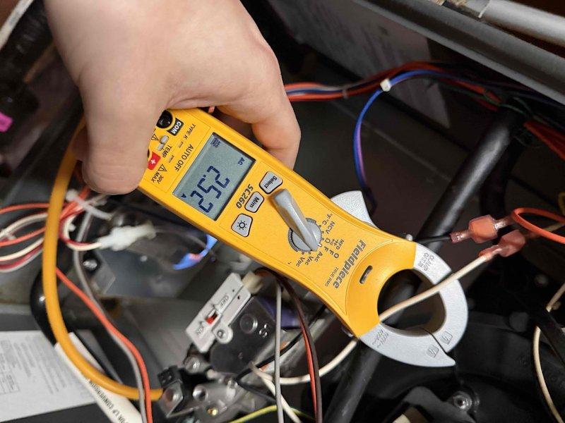 Performed diagnostic evaluation on furnace system noting inadequate temperature differential between ambient room temperature (65-68°F) and supply air (95-98°F). Conducted electrical testing with clamp meter showing 35.2 amps and verified temperature readings with digital thermometer displaying 49°F. Noted customer currently operating system without filter but has replacements on order.