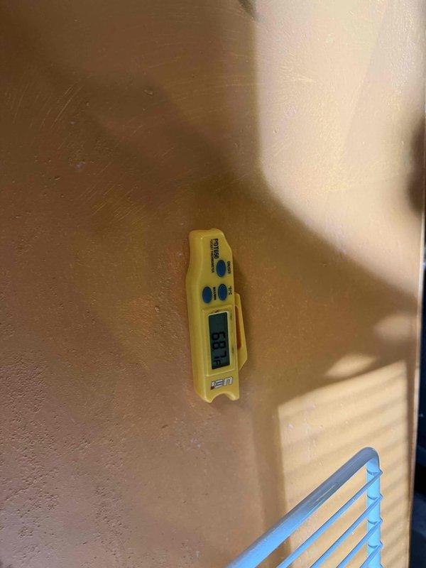 Performed diagnostic evaluation on furnace system noting inadequate temperature differential between ambient room temperature (65-68°F) and supply air (95-98°F). Conducted electrical testing with clamp meter showing 35.2 amps and verified temperature readings with digital thermometer displaying 49°F. Noted customer currently operating system without filter but has replacements on order.