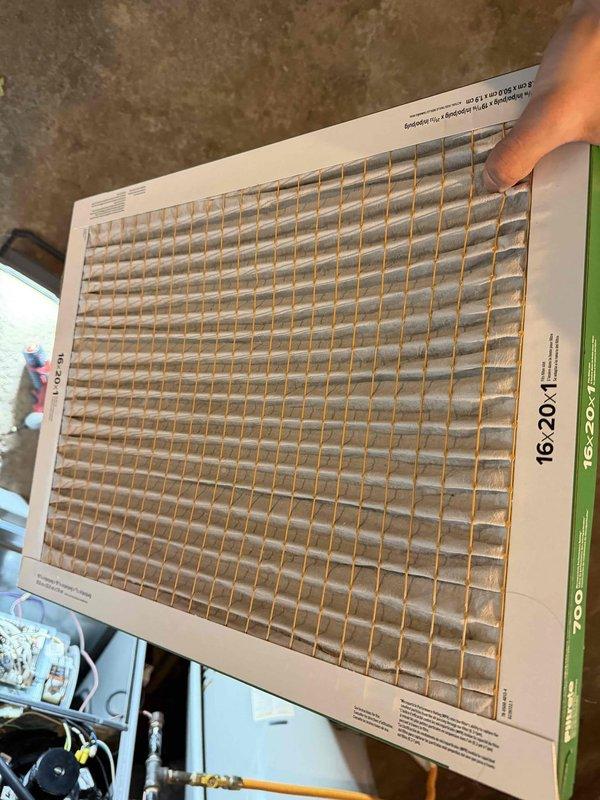 Responded to no heat complaint in heat pump system. Inspected and changed dirty air filter which was restricting airflow. Verified proper voltage supply (222V) to unit using Fieldpiece clamp meter. System now operating with improved heat output.
