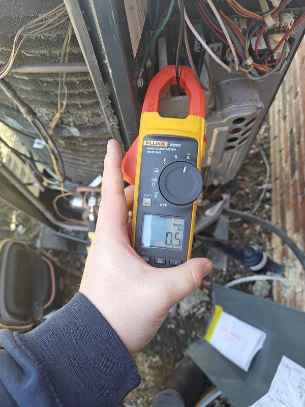 Performed regular maintenance inspection on cooling system, testing electrical components with clamp meter showing normal amperage readings (0.5 amps). Visually inspected outdoor condenser unit including fan assembly and protective grille, which showed normal wear with no significant issues. Customer renewed maintenance plan for upcoming cooling and heating seasons.