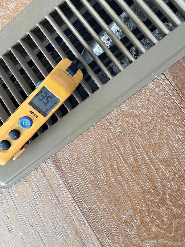 Diagnosed furnace with no heat issue by taking temperature measurements at both the coil (77.7°F) and floor vent (35°F), which confirmed significant heat loss in the system. Found severe dust accumulation on coil fins restricting airflow and installed new gas valve to restore proper heating function.