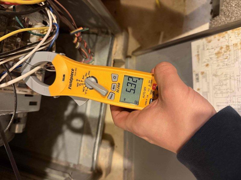Performed heating maintenance on system, including inspection of blower wheel which showed dust accumulation requiring cleaning. Conducted electrical diagnostics with readings of 33 amps on control circuitry, confirming system is operating within normal parameters.