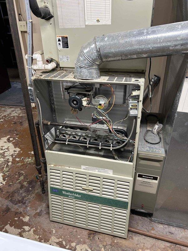 Conducted comprehensive inspection of aging Honeywell WeatherMaker furnace system for potential replacement. Evaluated existing ductwork connections, electrical components, and drainage system in utility room. Prepared separate quotations for furnace-only replacement option and complete HVAC system replacement including both furnace and air conditioning units as requested by customer.