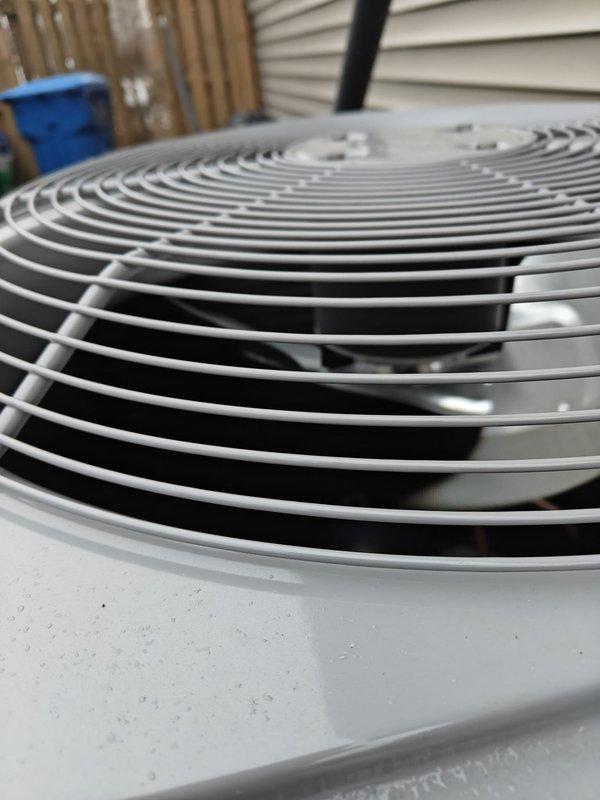 Performed annual heating maintenance service on residential system. Conducted electrical testing with Fluke clamp meter, measuring current draw at 0.9 amps. Inspected outdoor unit fan grill for proper condition and airflow, confirming no obstructions or damage to protective cover.