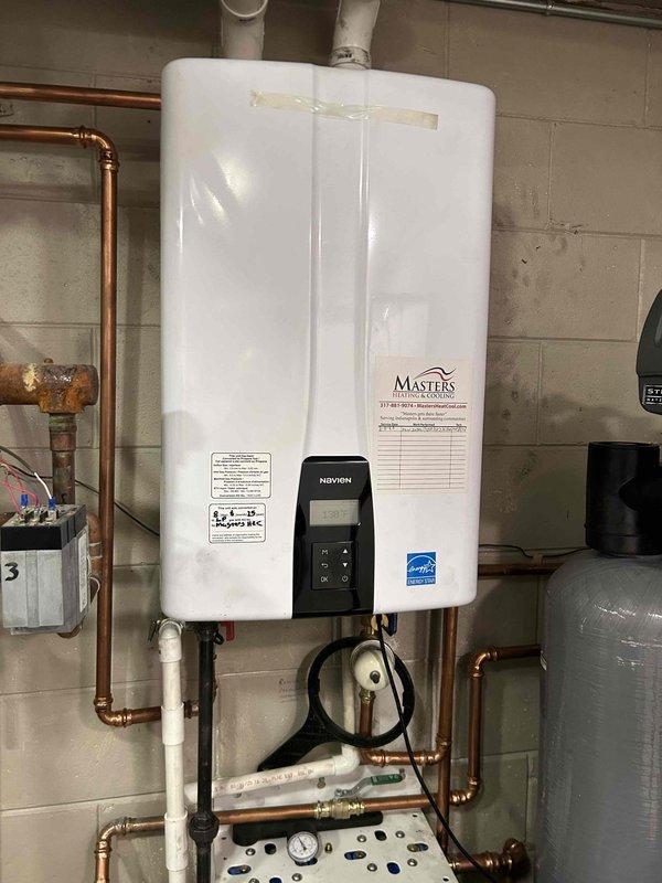 Conducted assessment for customer interested in replacing their propane-fueled boiler system with a heat pump due to high monthly propane costs. Inspected existing Navien tankless water heater installation and examined interior ductwork condition to evaluate compatibility with potential heat pump system.