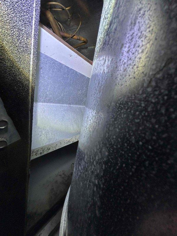 Conducted assessment for customer interested in replacing their propane-fueled boiler system with a heat pump due to high monthly propane costs. Inspected existing Navien tankless water heater installation and examined interior ductwork condition to evaluate compatibility with potential heat pump system.