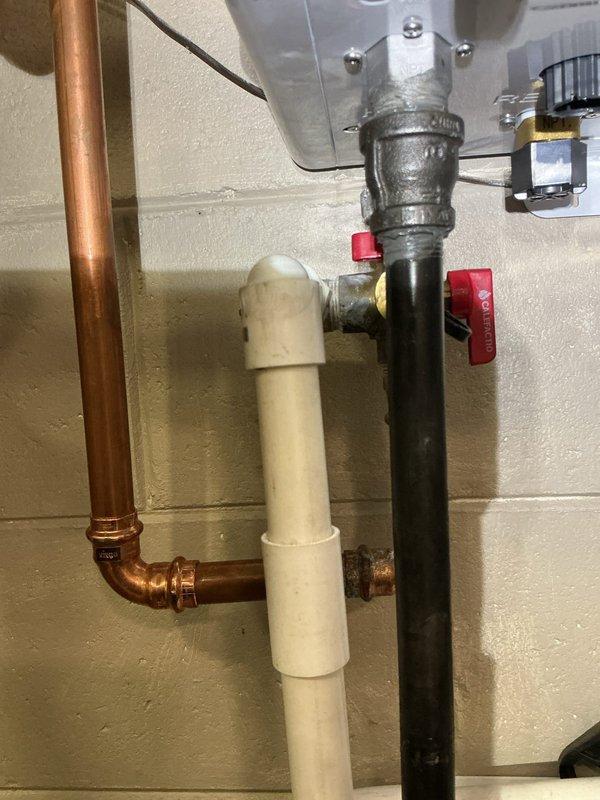 Addressed water heater plumbing leak by replacing deteriorated brass pipe fitting and valve assembly. Installed new NPT-compatible components, including shut-off valve with red handle, and ensured proper connection between copper and PVC sections. System tested and confirmed watertight after repair.