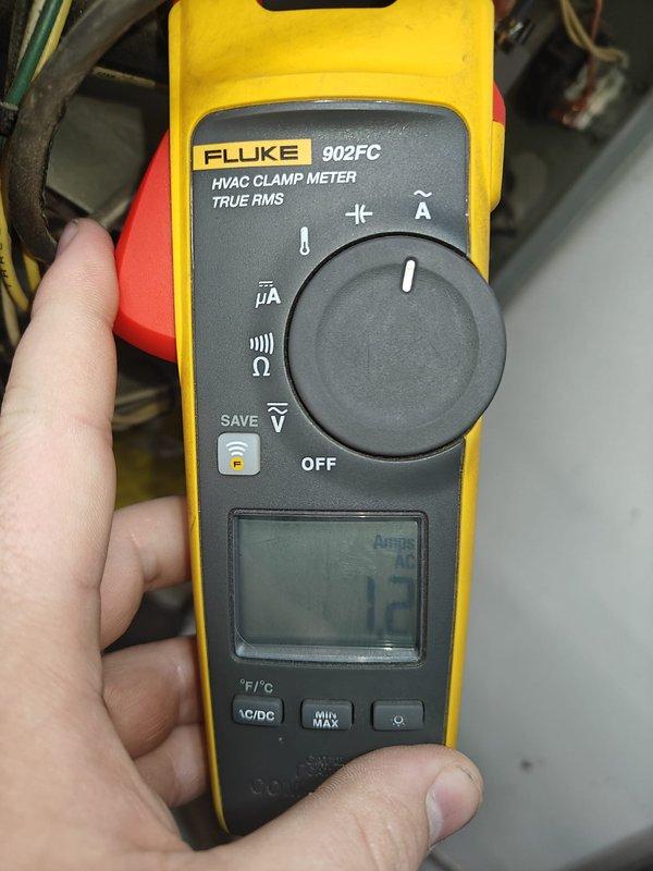 Performed annual heating maintenance service on residential unit. Inspected system components and connections in tight utility space. Tested electrical parameters with Fluke 902FC HVAC Clamp Meter, recording measurements of 1.3 amps, confirming system is operating within normal parameters.