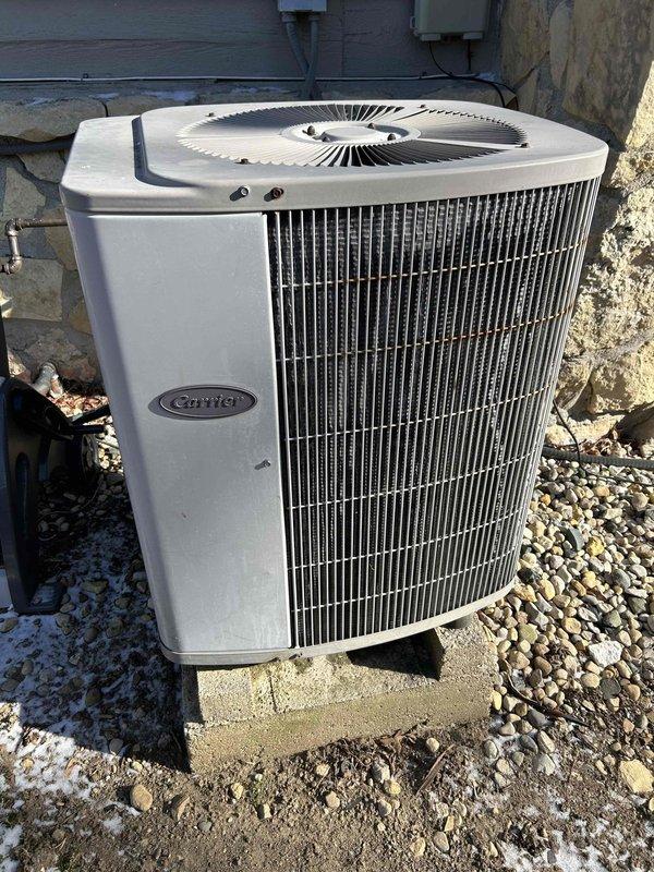 Performed turnover furnace estimate for a residential property with an existing Carrier air conditioning system showing signs of weathering. Inspected the mechanical room which contains the HVAC equipment, water heater, and associated plumbing infrastructure with PVC piping. Documented current system condition for replacement proposal.