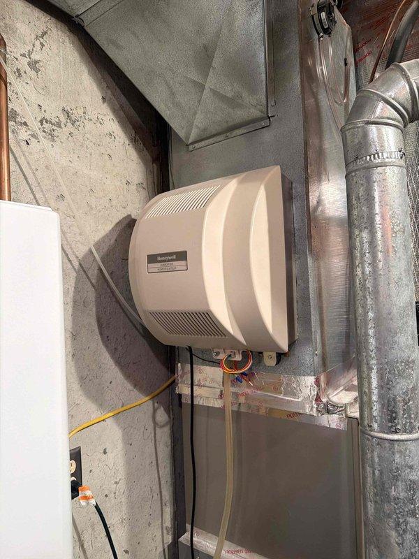 Responded to customer complaint of loud furnace noise. Upon inspection, discovered severely clogged air filter causing restricted airflow and system strain. Replaced dirty filter and checked Honeywell humidifier connections, confirming proper operation of the system after service.