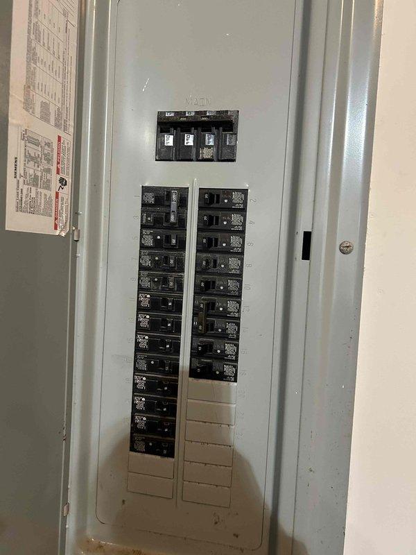 Conducted assessment for replacement of two aging HVAC units for returning customer who had previous installation 5 years ago. Inspected existing WeatherKing outdoor unit showing signs of deterioration with vegetation encroachment around the equipment. Evaluated electrical service panel to ensure adequate capacity for potential new installation, noting current breaker configuration and available spaces for system upgrades.