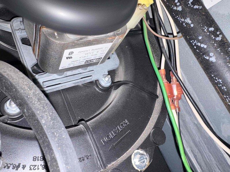 Inspected furnace due to customer report of intermittent shutdowns requiring manual reset by "jiggling" wire. Visual inspection revealed blower motor assembly with potential wiring connection issues. Identified loose/corroded connections at motor terminals and evidence of wire harness strain. Secured connections and stabilized wiring to prevent future disconnections.