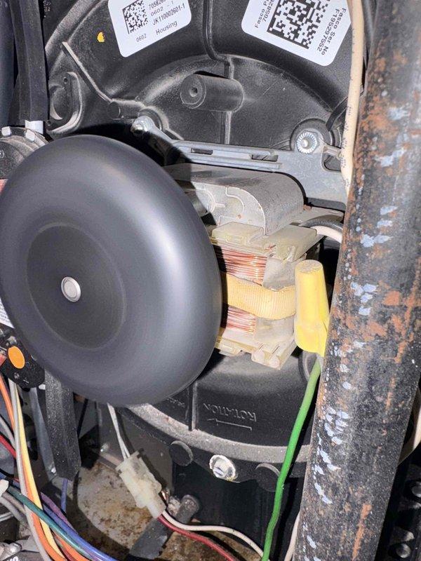 Inspected furnace due to customer report of intermittent shutdowns requiring manual reset by "jiggling" wire. Visual inspection revealed blower motor assembly with potential wiring connection issues. Identified loose/corroded connections at motor terminals and evidence of wire harness strain. Secured connections and stabilized wiring to prevent future disconnections.